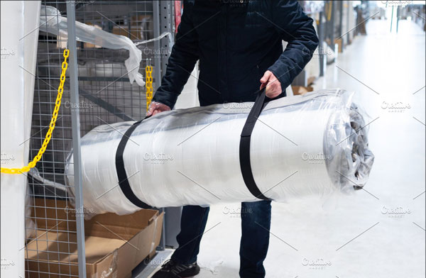 Man Holding Roll of Mattress Mockup