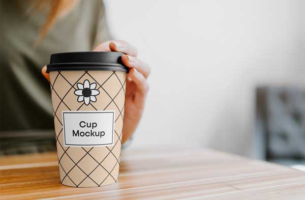 free Coffee Cup with Hand Mockup